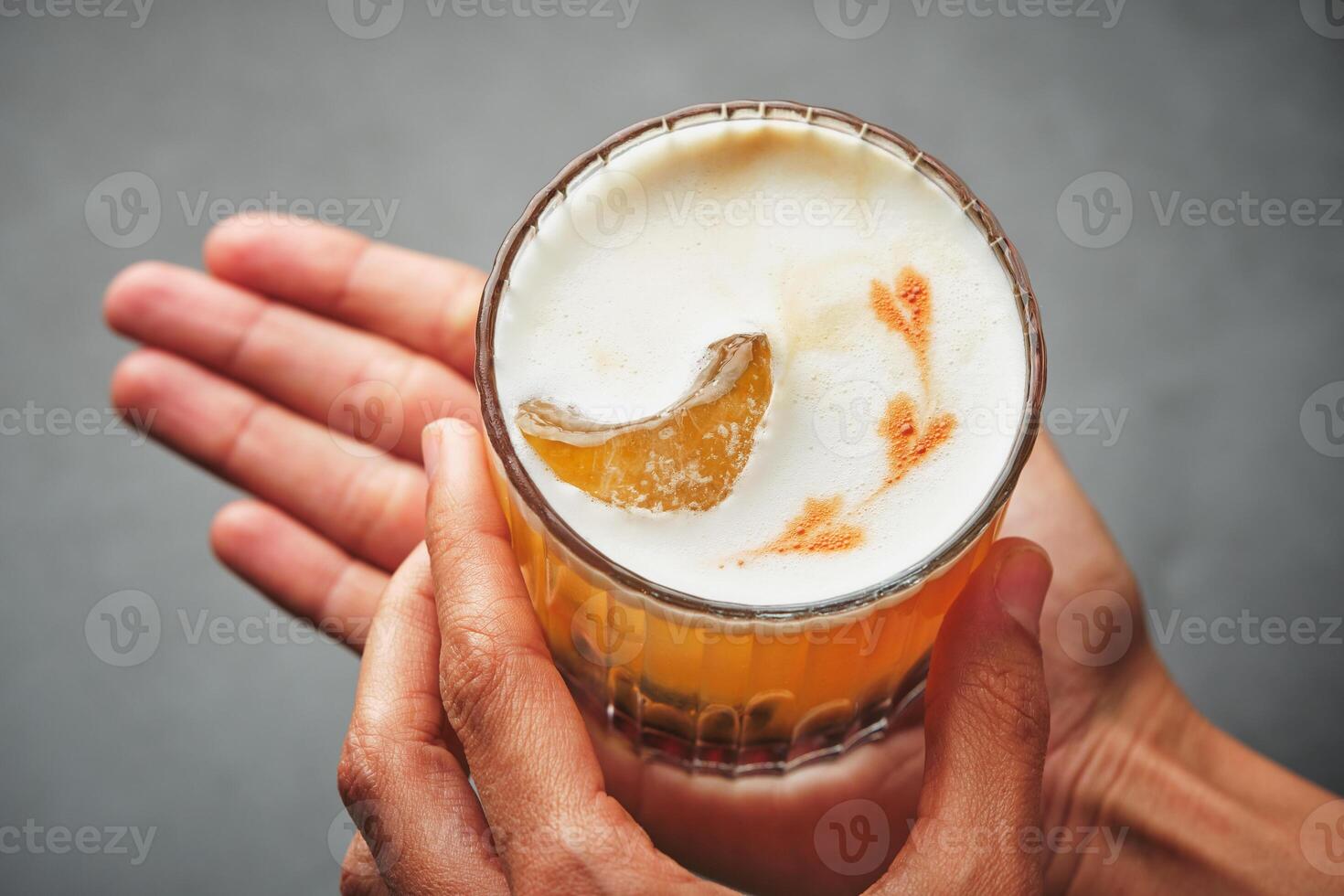 A person holding a glass with a drink in it photo