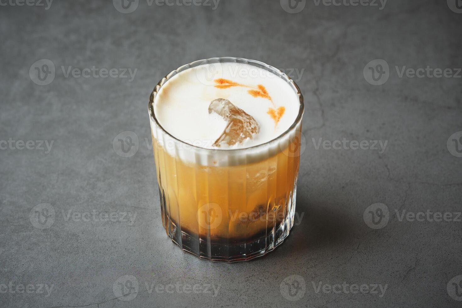 A glass of orange juice with ice on top photo