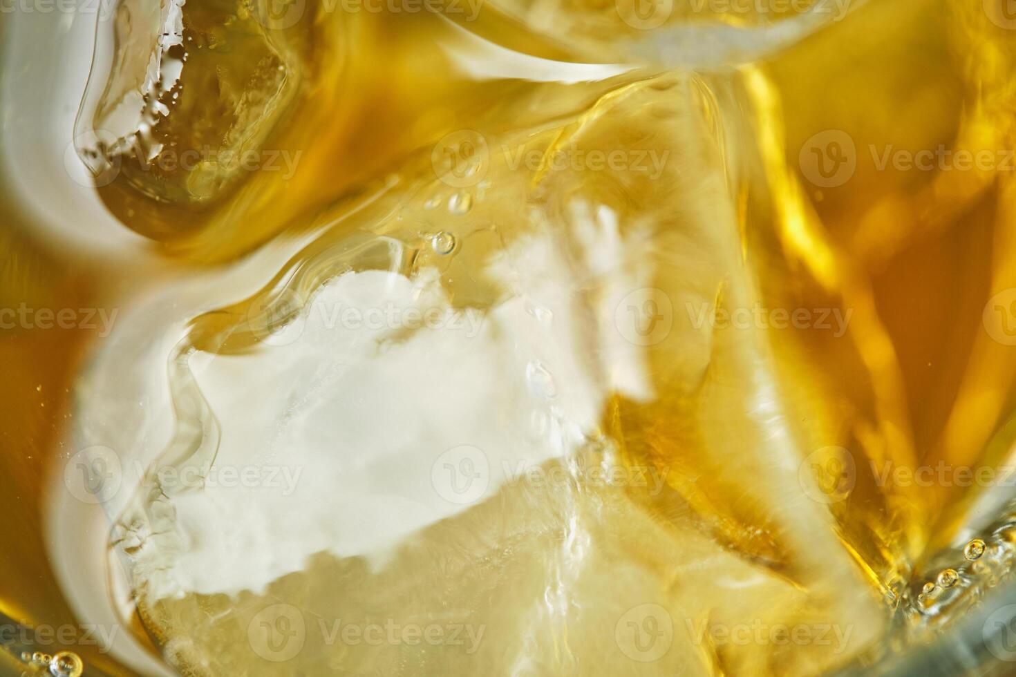 A close up of ice cubes in a glass of beer photo