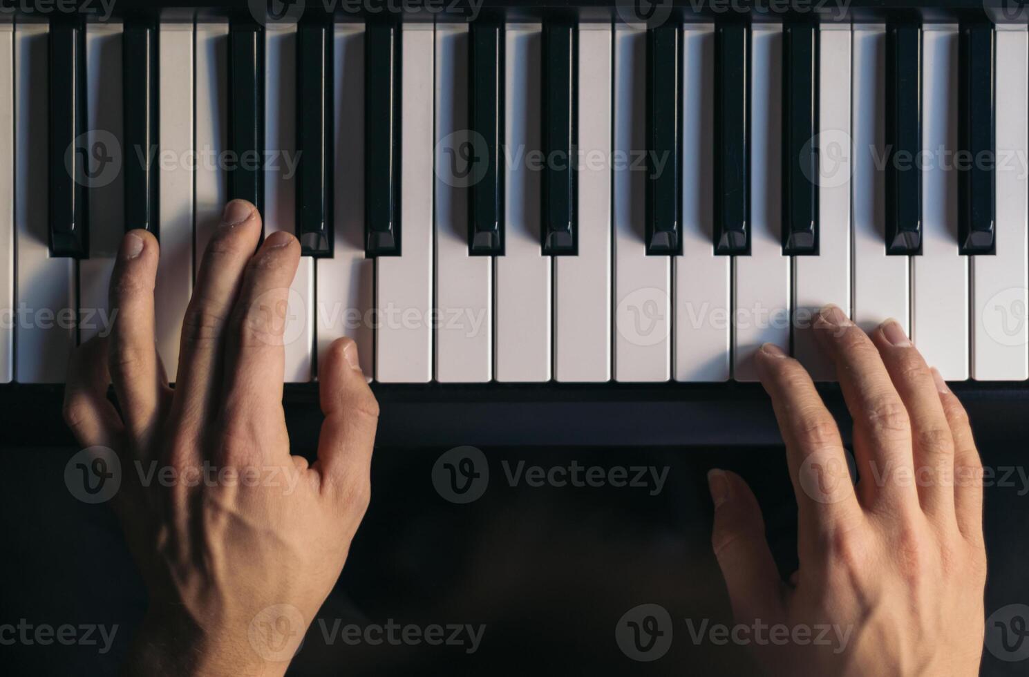 man playing piano. top view. photo