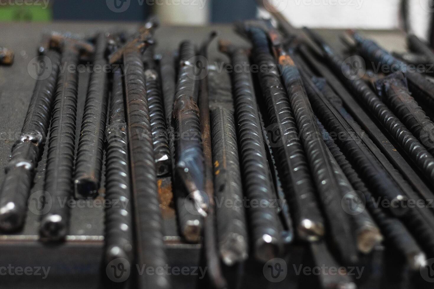 Workbench with assorted metal rods in workshop photo