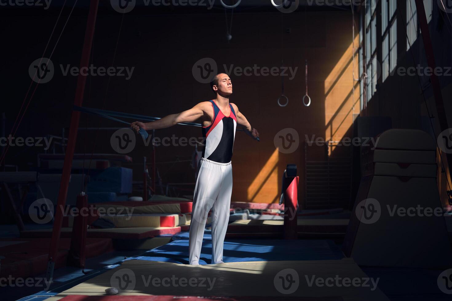 Young sports gymnast stretching with a rubber band in the gymnas photo
