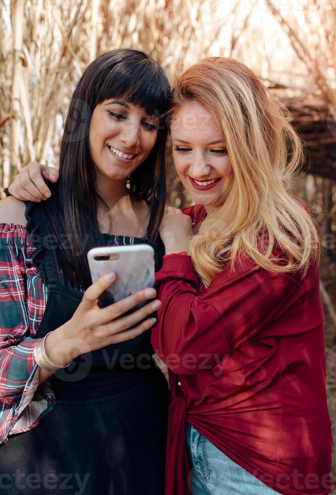 Young women looking in smartphone photo