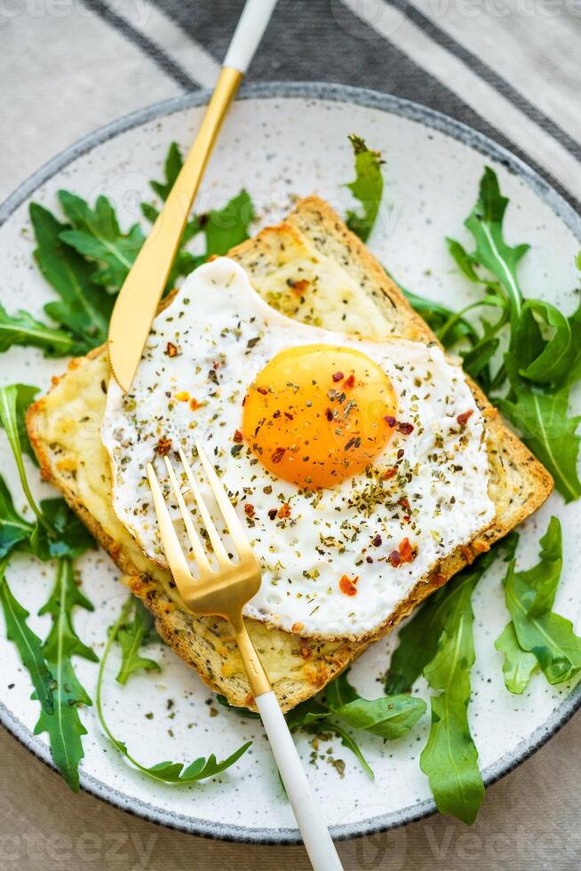 Delicious breakfast of fried eggs with toast and salad. photo