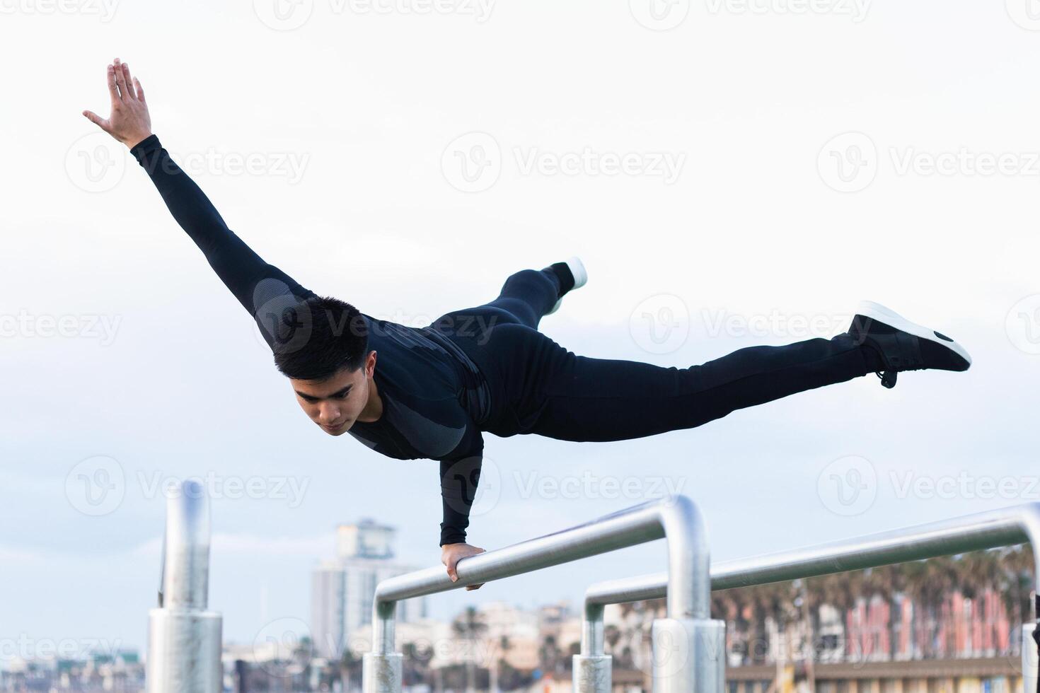 Athlete doing exercise on parallel bars photo