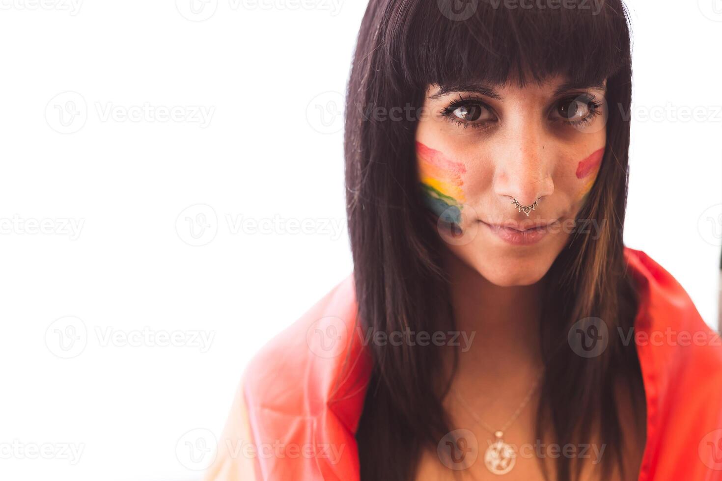 Brunette woman with LGBT symbol on face straightening hair photo