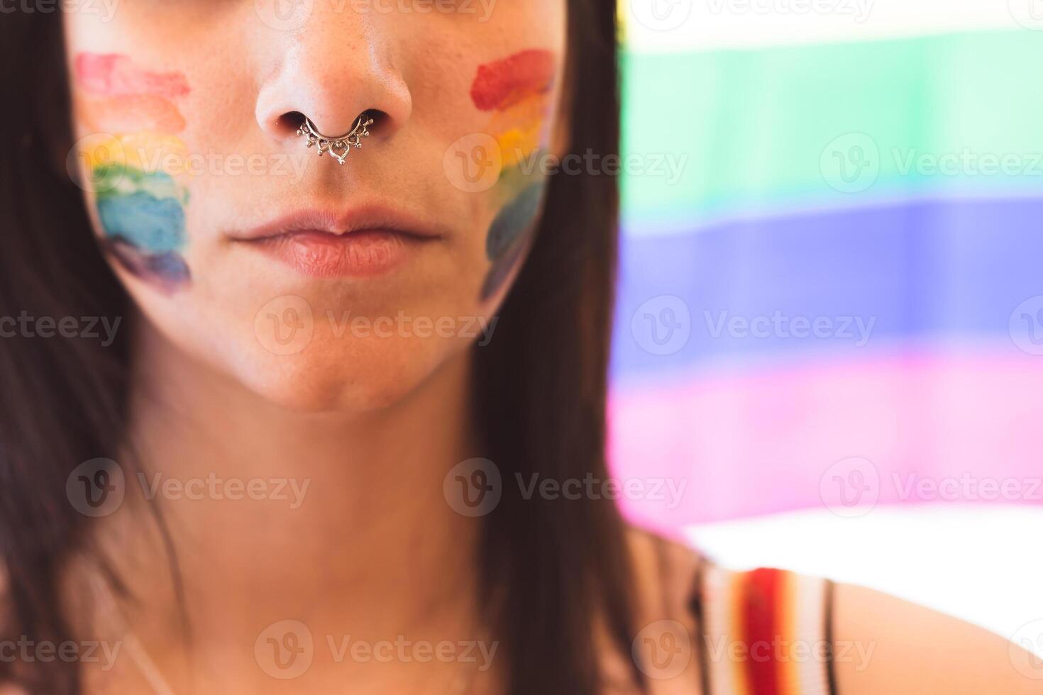 Brunette woman with LGBT symbol on face straightening hair photo