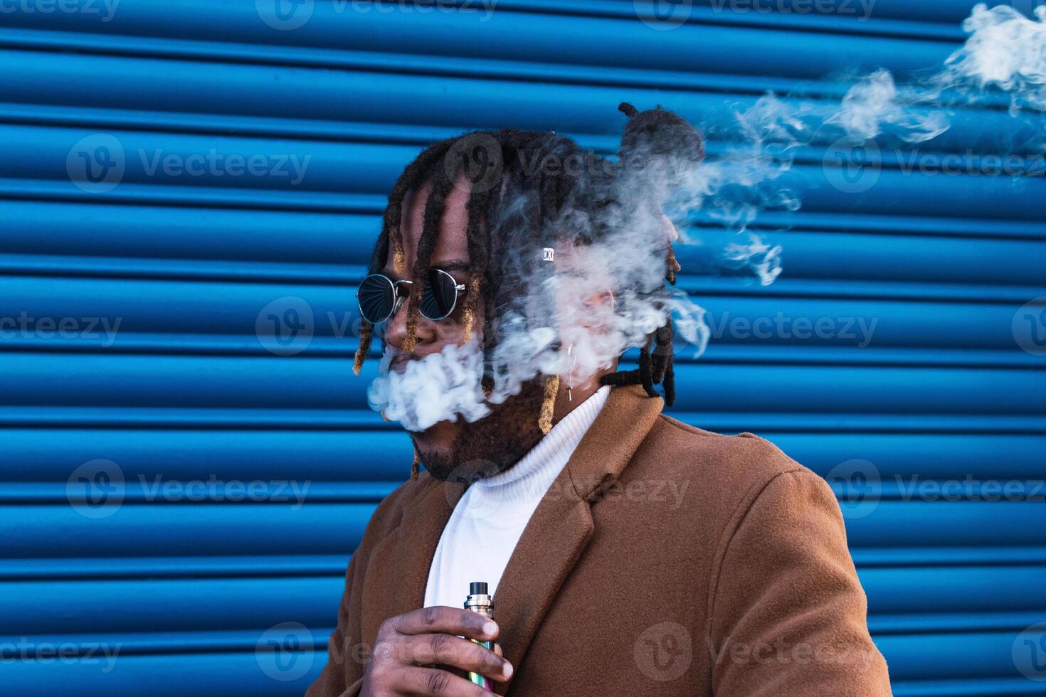 Hipster black man with electronic cigarette photo