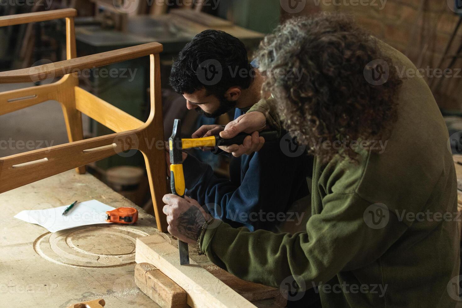 Male artisans creating wooden furniture in workshop photo