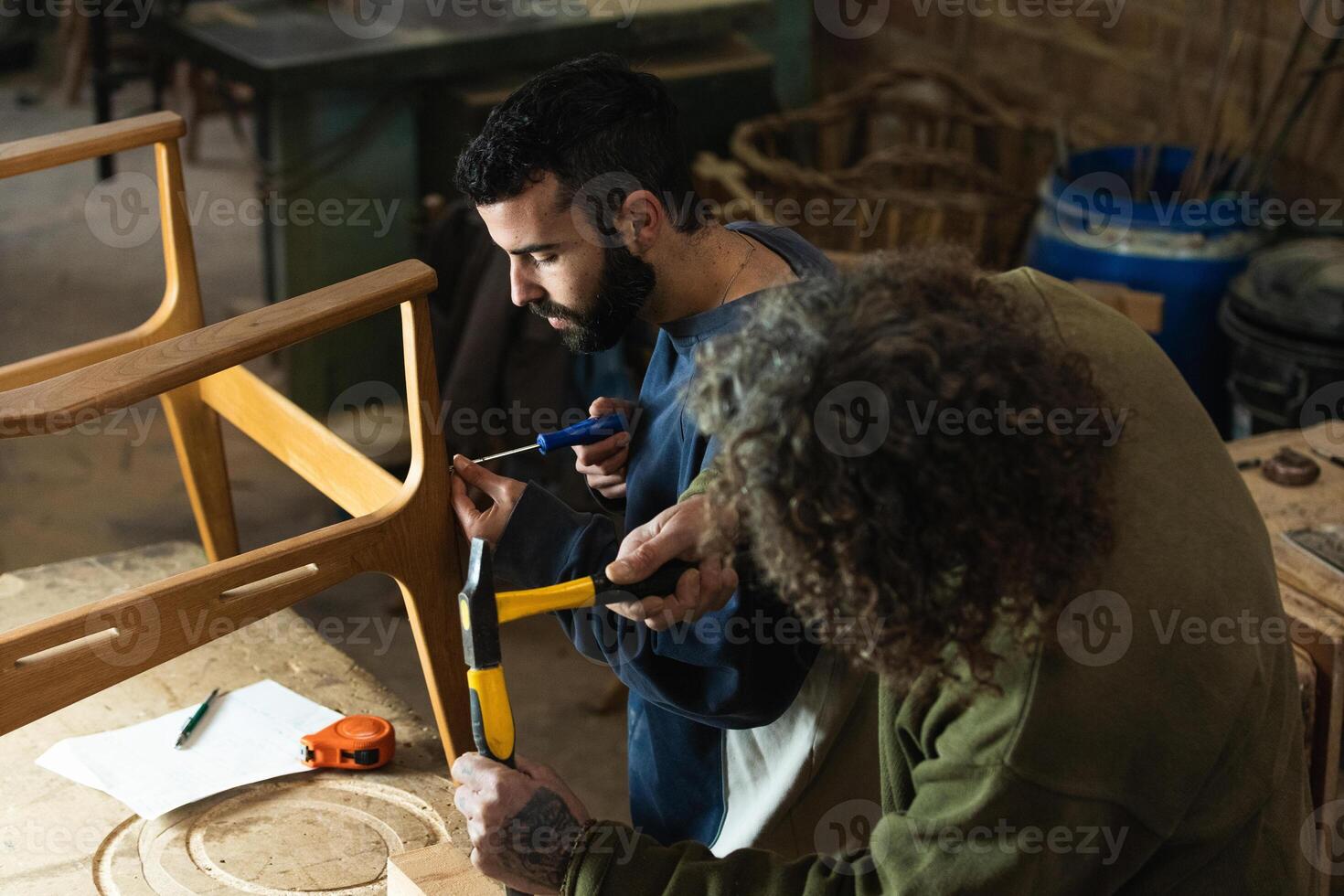 Male artisans creating wooden furniture in workshop photo