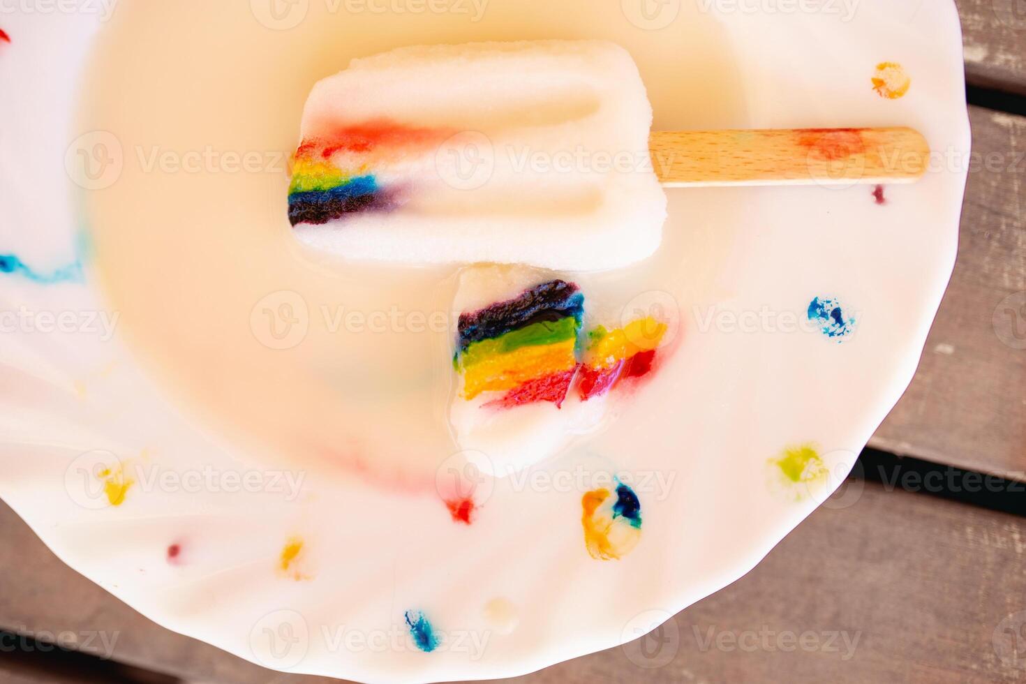 Ice cream on wooden stick with LGBT symbol on decorated plate photo