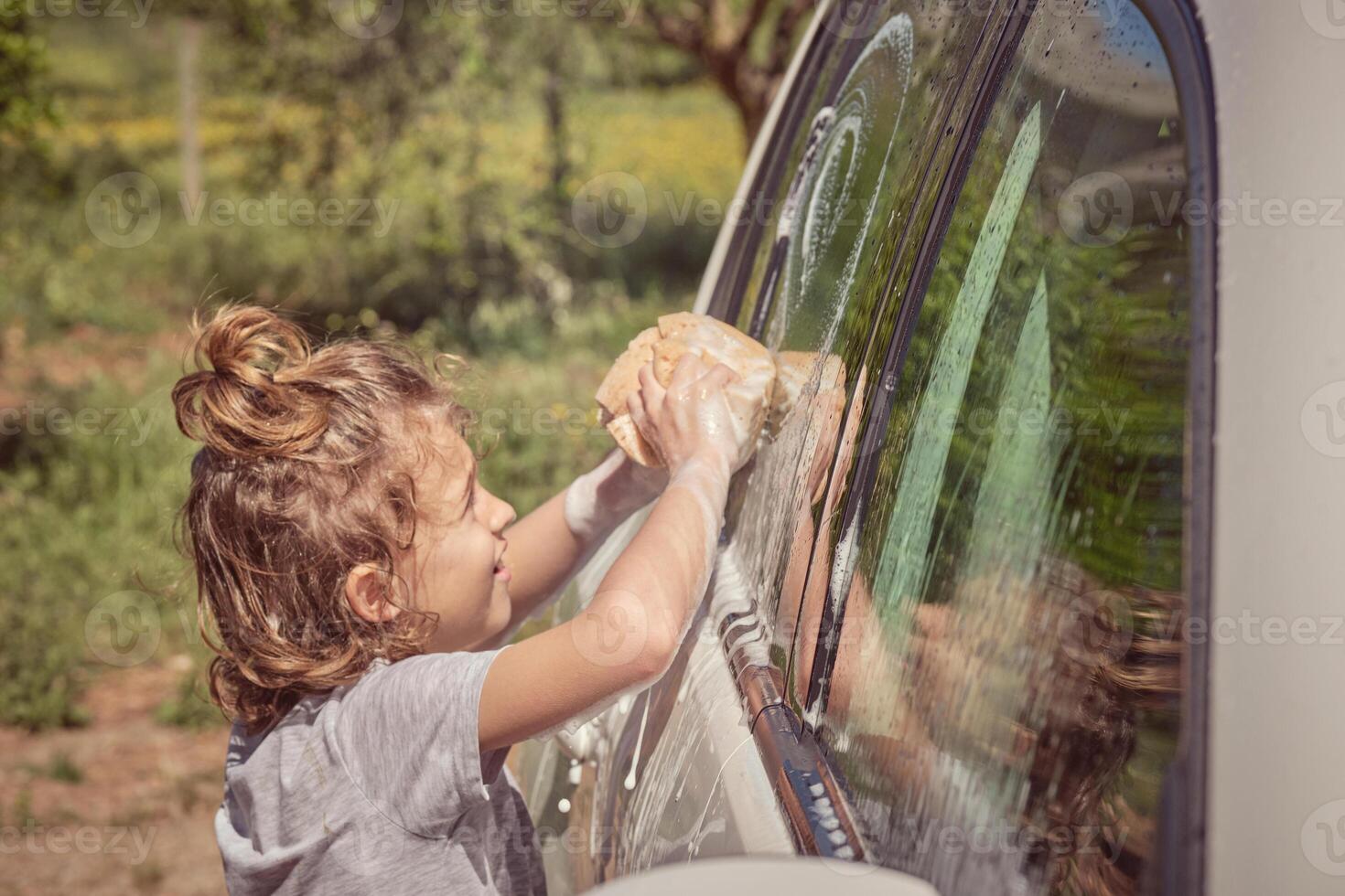 Little boy washing car on sunny day photo