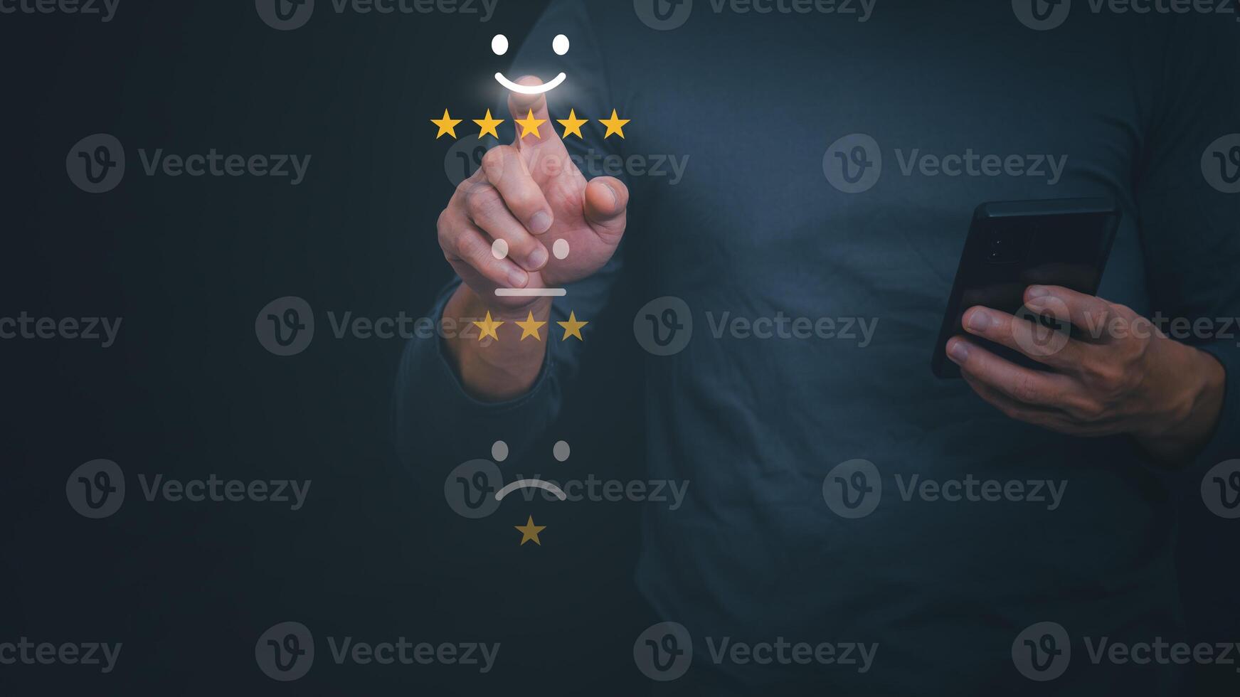 a man is holding a smartphone with five stars on it photo