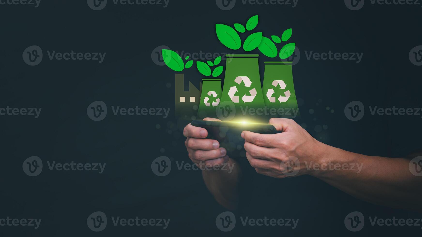 man holding smartphone with recycling symbol and plants on dark background photo
