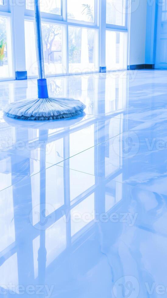 Mop cleaning shiny modern floor in sunlit room with large windows photo