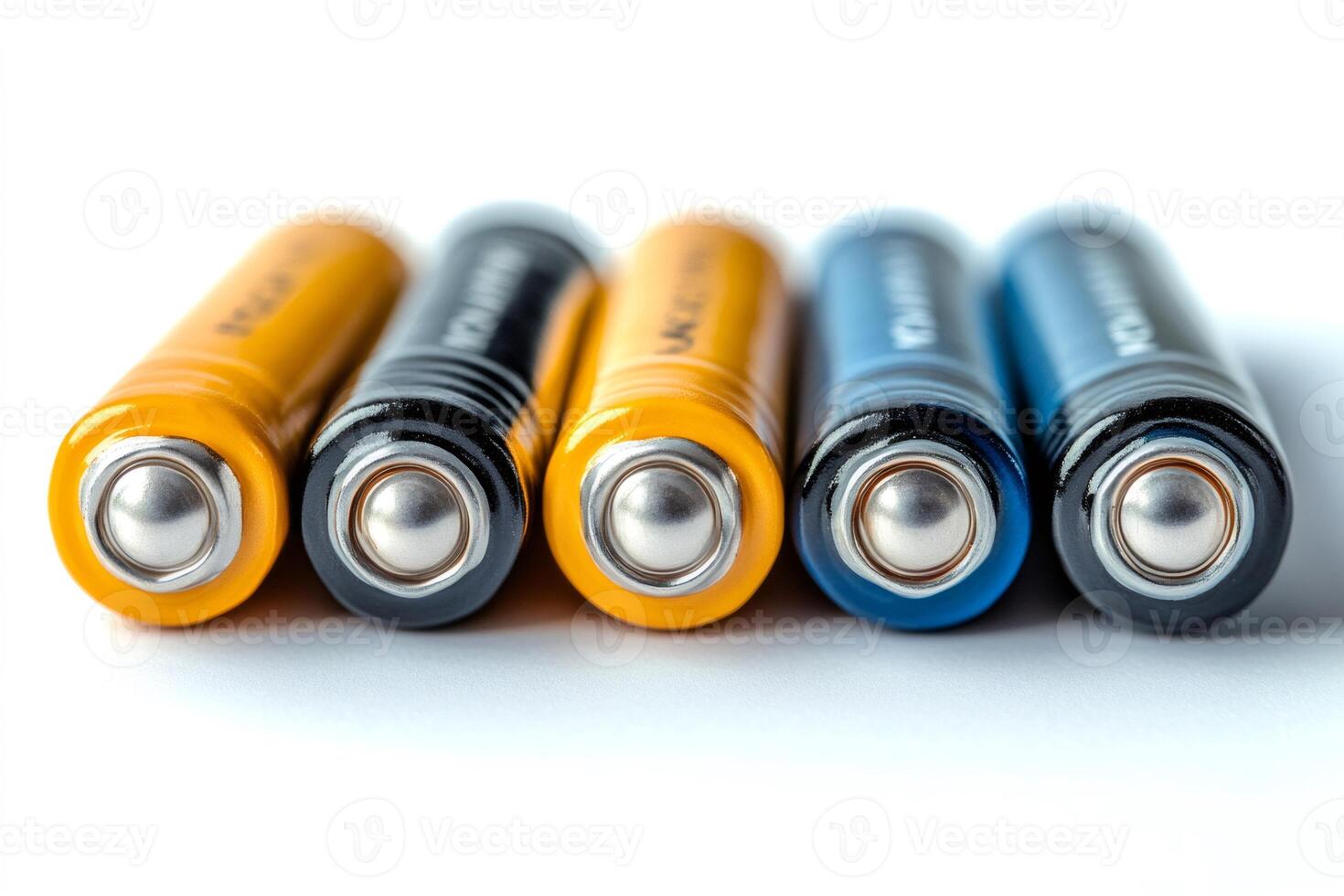 Row of colorful aa batteries laying on white background photo