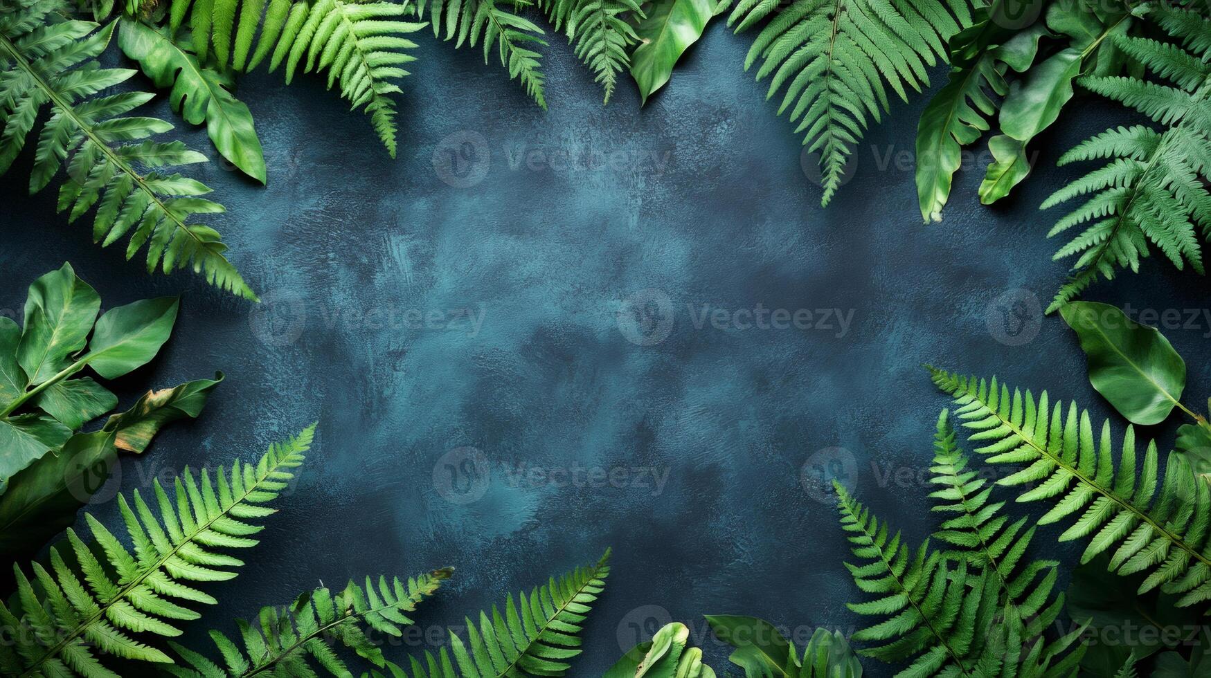 Tropical green leaves creating frame on dark background photo