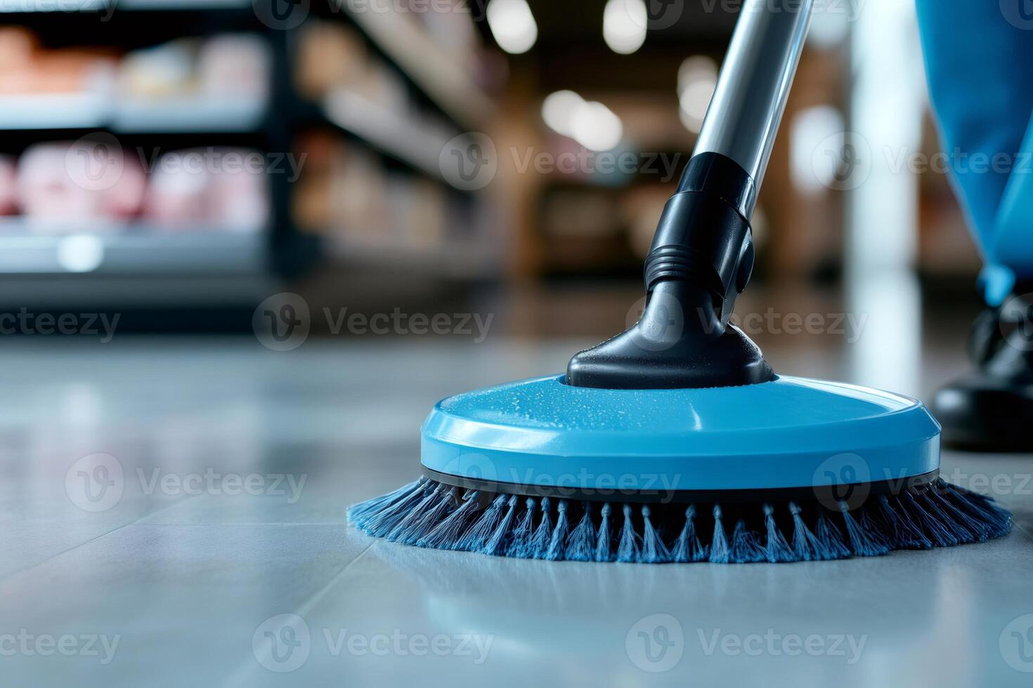 Janitor cleaning supermarket floor with modern scrubbing machine photo