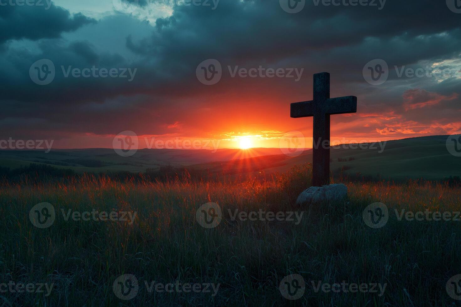 Large wooden cross standing on hilltop during sunset with dramatic sky photo