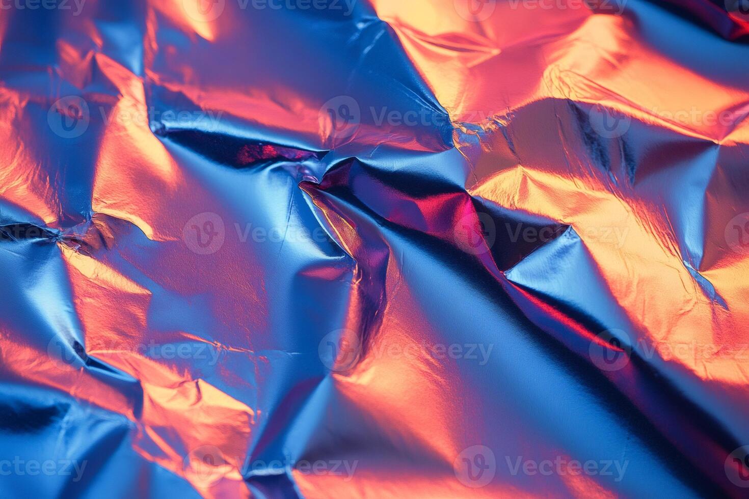 Crumpled holographic foil reflecting vibrant colors creating abstract texture photo
