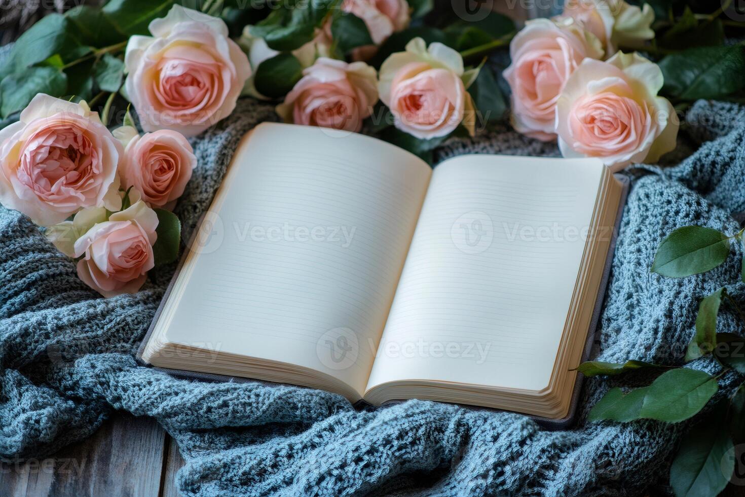 Open notebook surrounded by roses on cozy blanket, capturing moments of inspiration photo