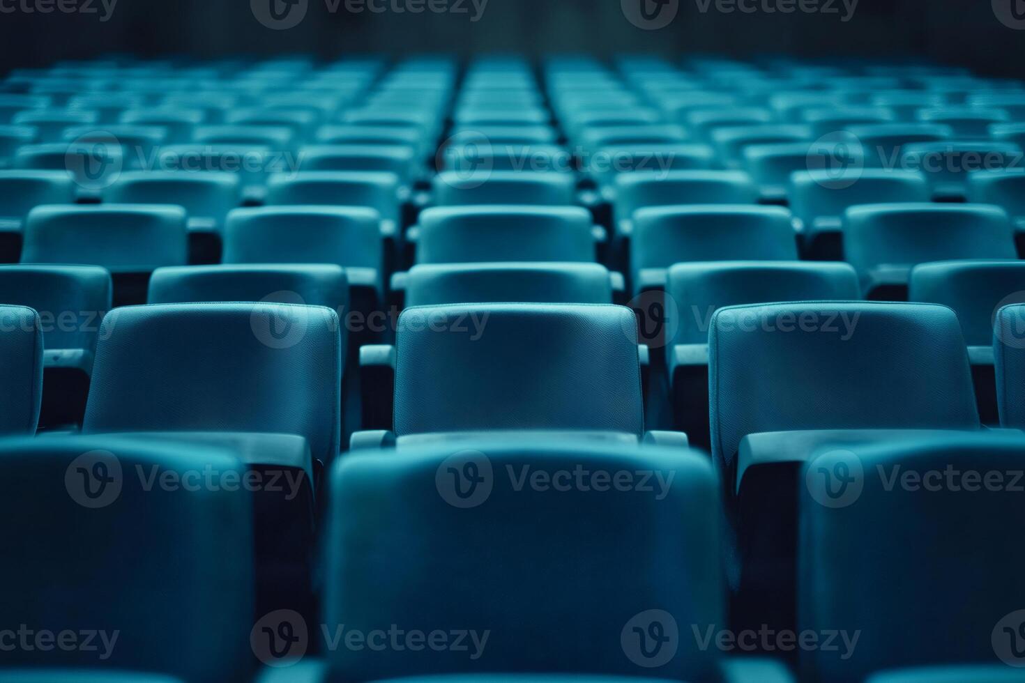 Empty blue seats filling large auditorium awaiting audience arrival photo
