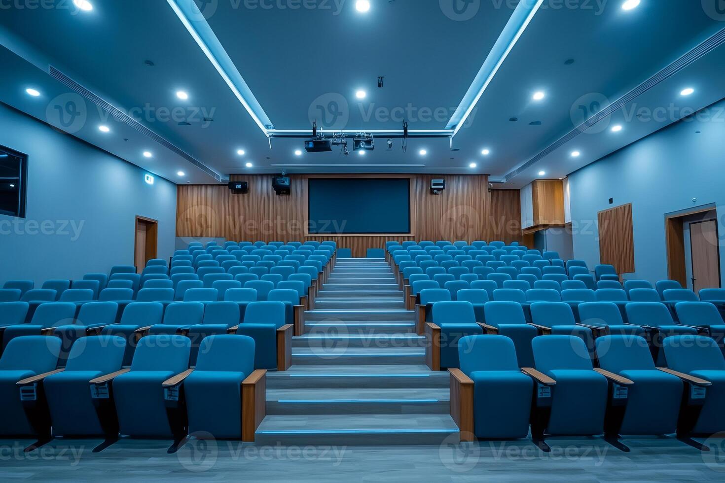 Empty modern conference hall with blue seats and stage lighting photo
