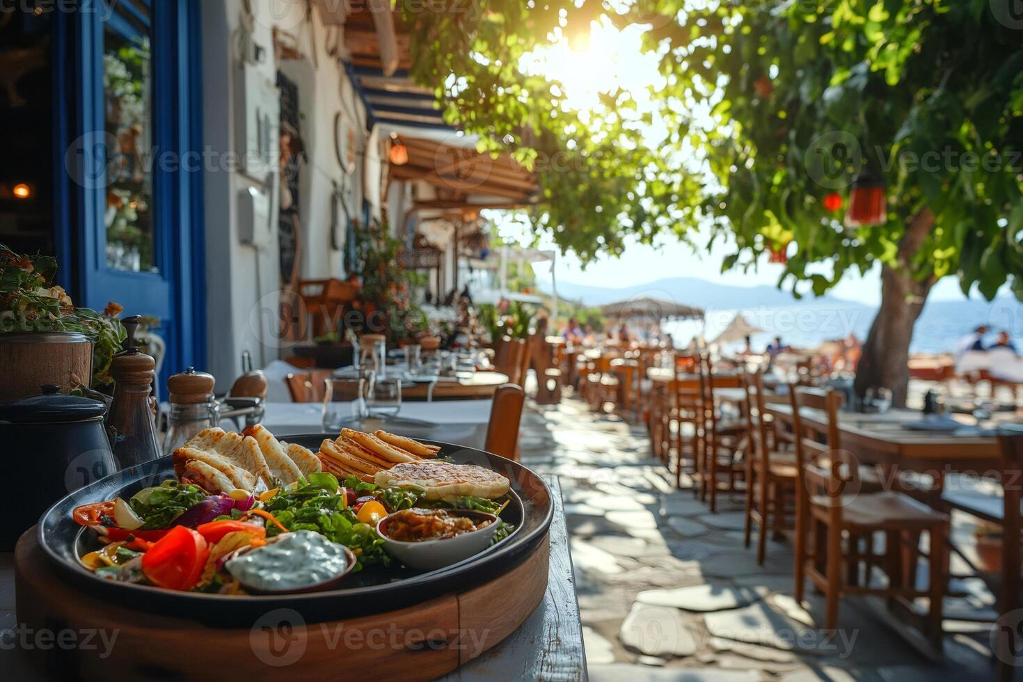 Greek salad and pita bread enjoying sunshine in seaside restaurant photo