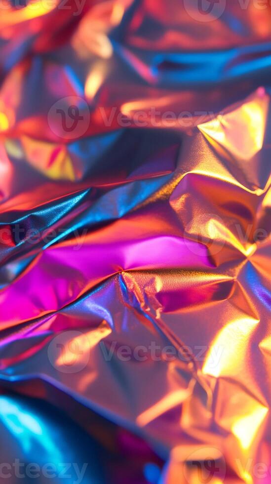 Crumpled holographic foil reflecting vivid colors creating abstract texture photo