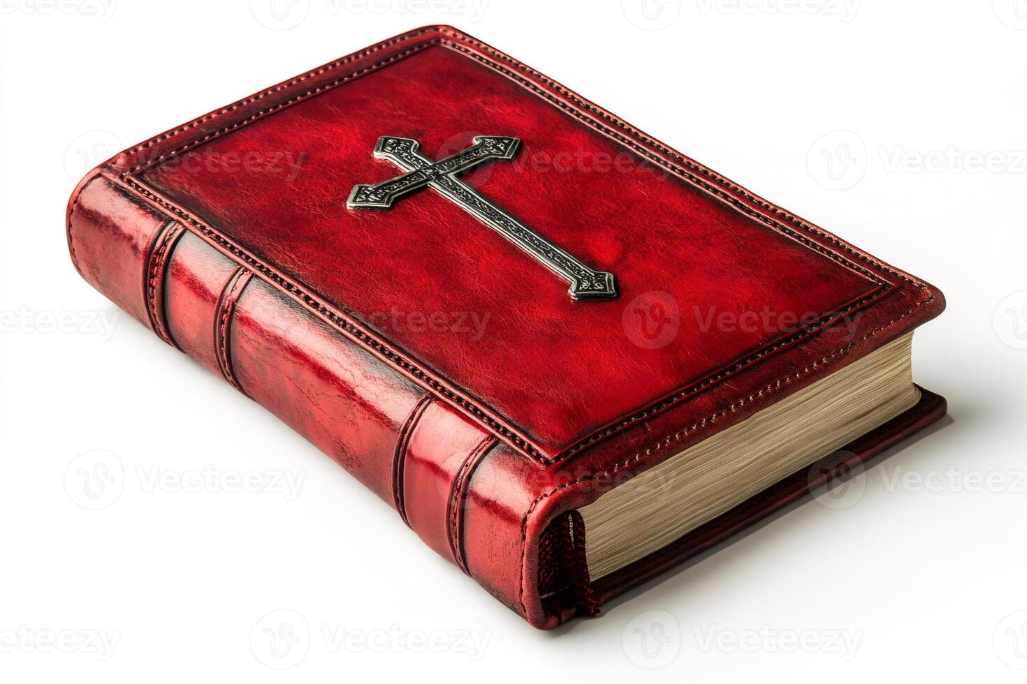 Red leather bound holy bible with silver cross resting on white background photo