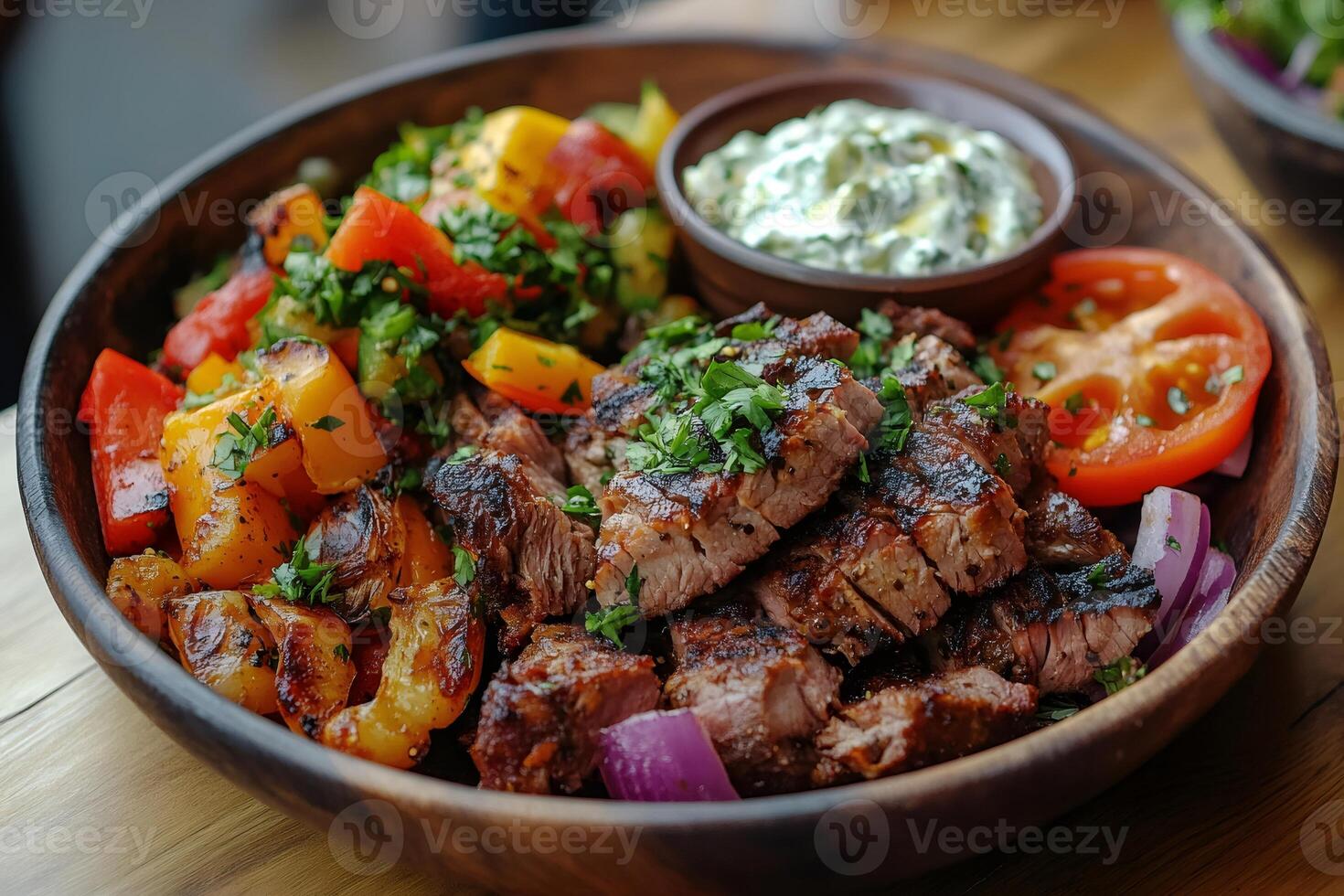 Sizzling grilled steak with roasted vegetables and creamy yogurt sauce photo