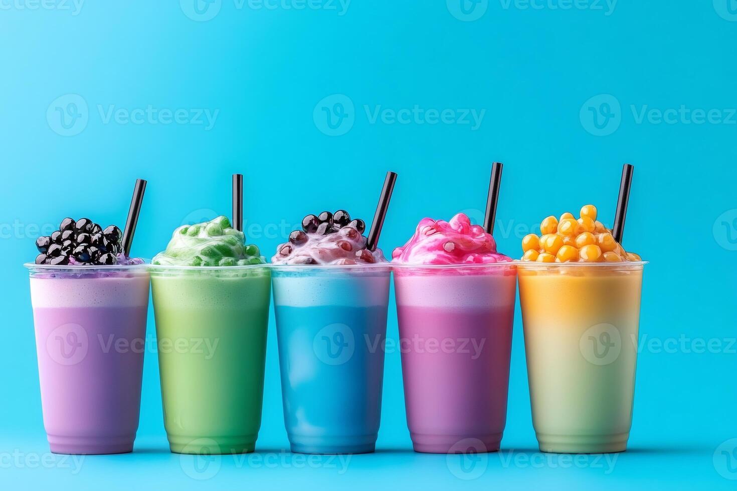 Colorful bubble tea drinks with toppings and straws on blue background photo