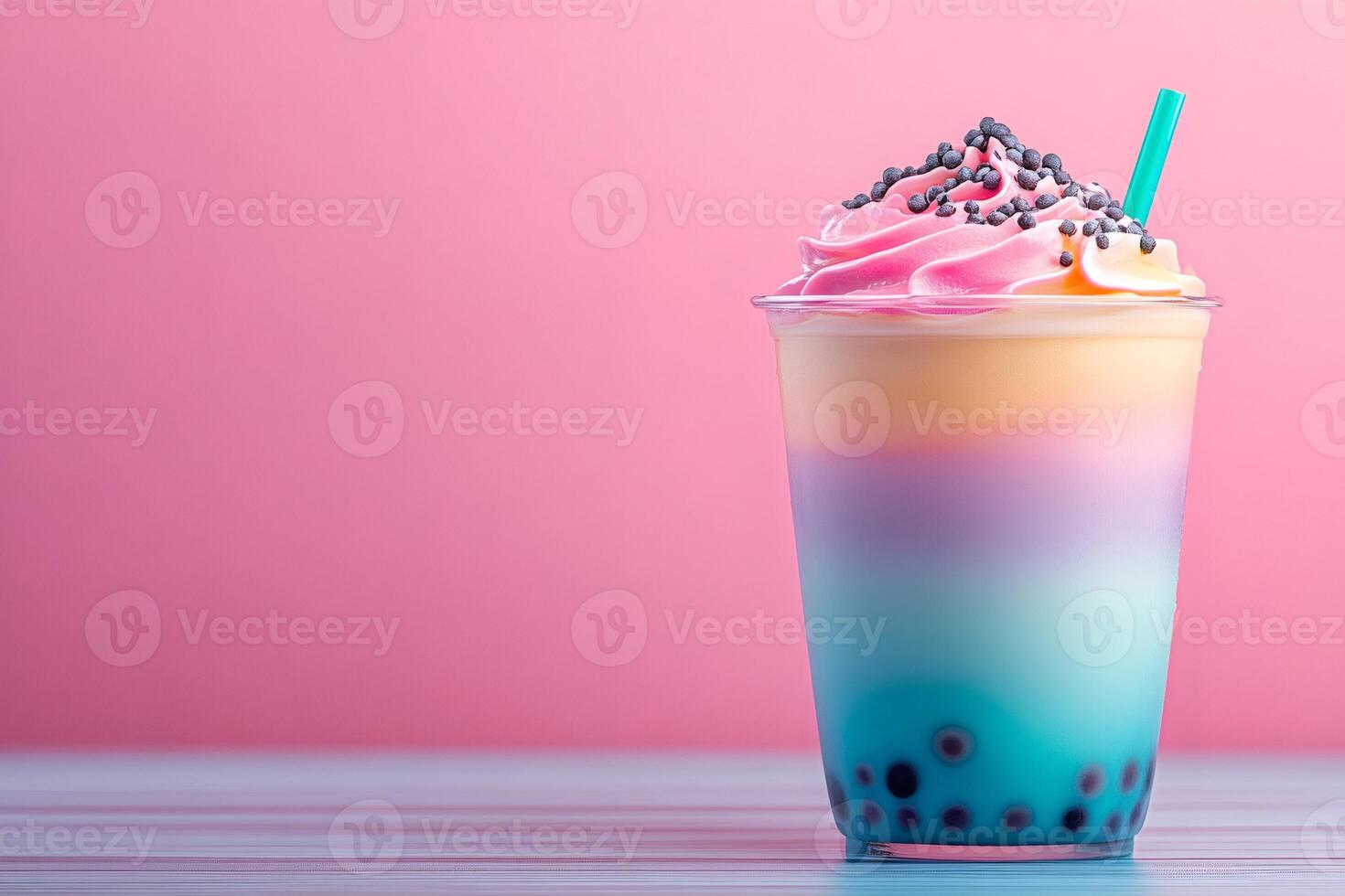 Rainbow bubble tea with whipped cream and chocolate sprinkles on pink background photo