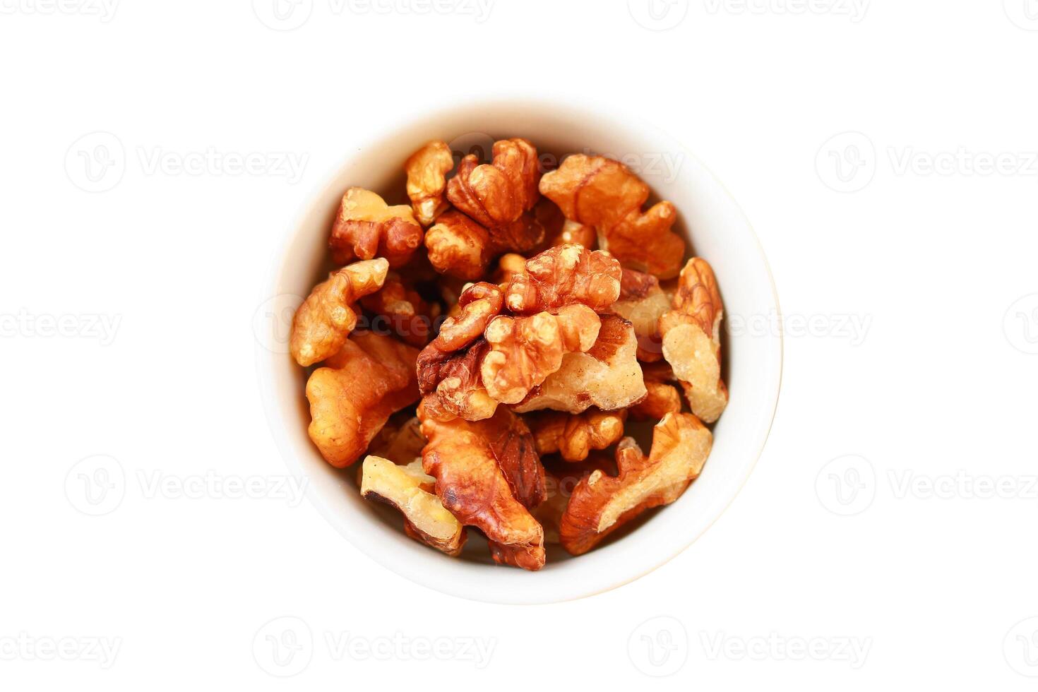 Peeled walnuts in a white bowl on a white background, isolated, Clipping path photo