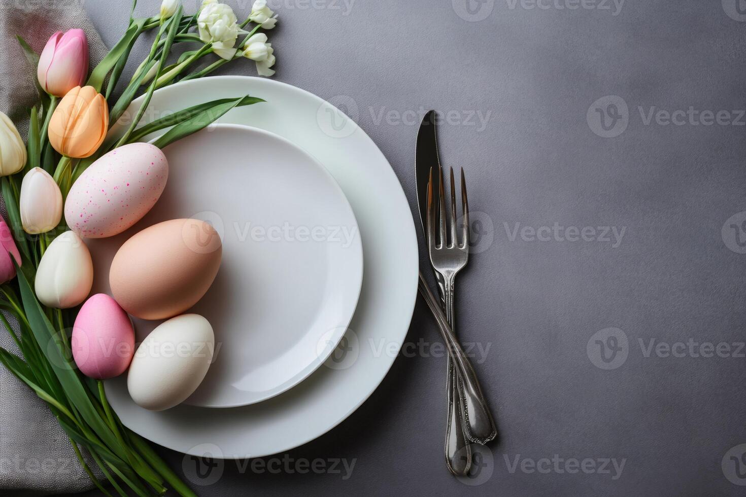 Easter table setting decorated with colorful eggs and tulips photo