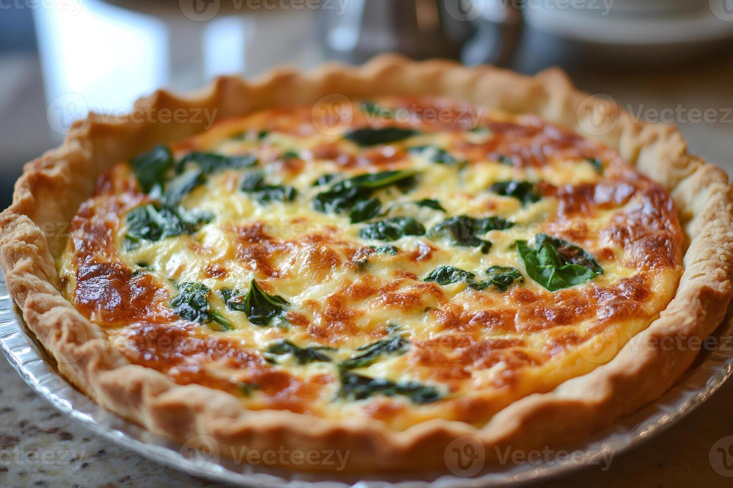 Delicious spinach and cheese quiche resting on kitchen counter photo