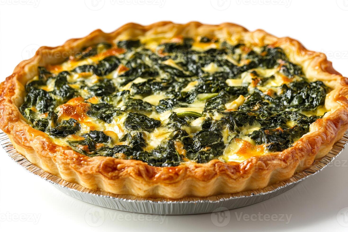Delicious spinach quiche baking in a round baking pan photo