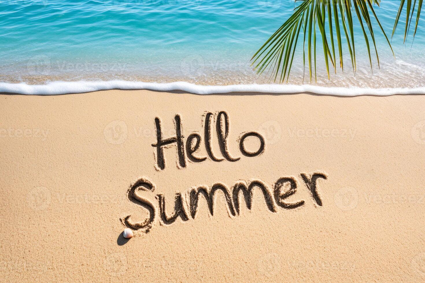 Hello summer written on beach sand with palm tree leaf and turquoise water photo