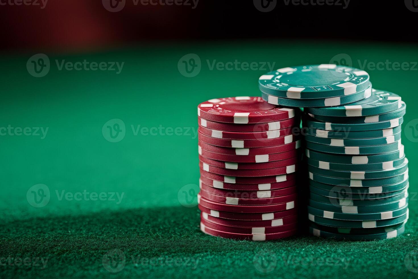 Poker chips stacked on green felt table illuminating gambling theme .. photo