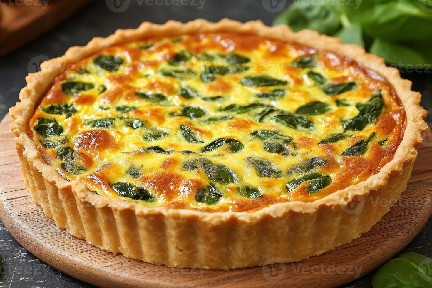 Delicious spinach quiche resting on wooden board, freshly baked and ready to eat photo