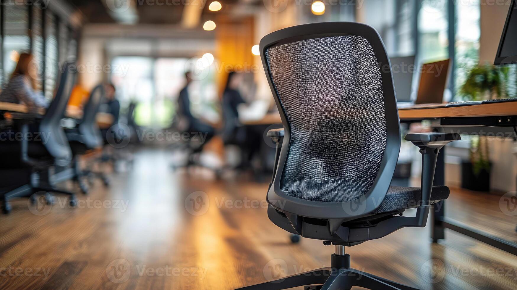 Ergonomic office chair stands empty in modern coworking space with blurred colleagues working photo
