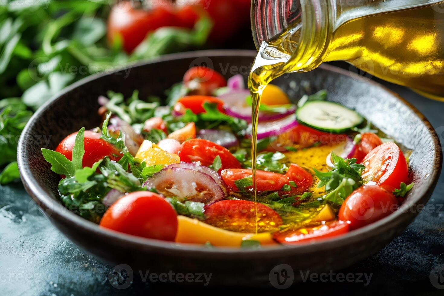 Pouring olive oil over fresh vegetable salad with cherry tomatoes, cucumber, and arugula photo
