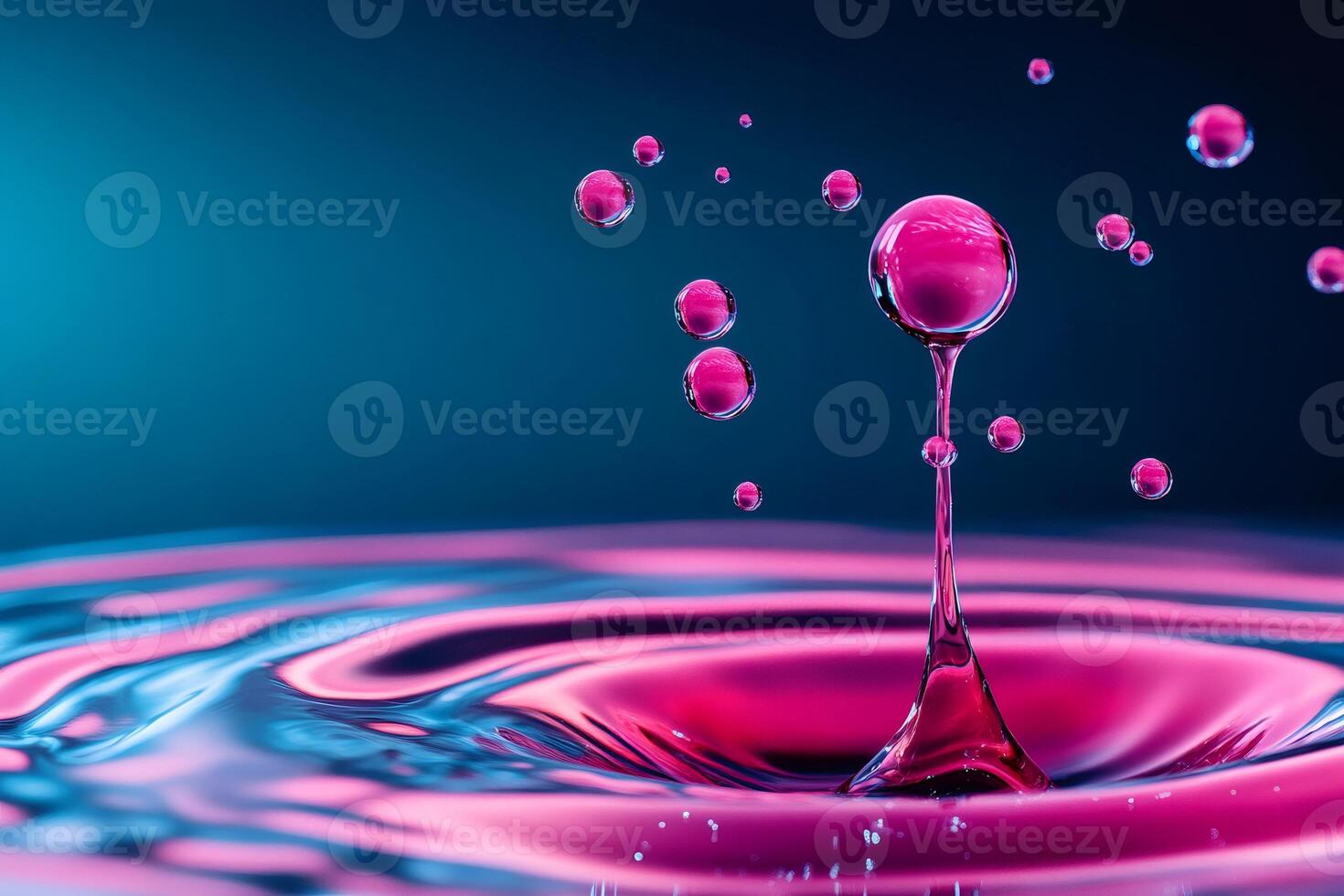 Pink water droplet splashing and creating small bubbles photo