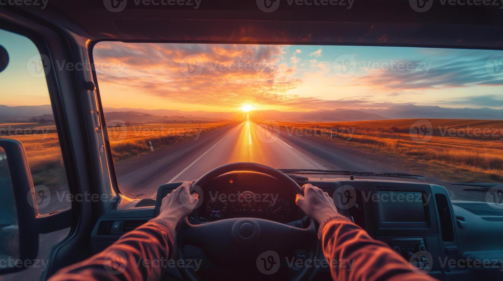 Truck driver driving into the sunset on a country road photo