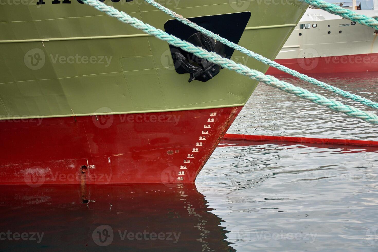 Close-up of the bow with draft and waterline scale of a fishing boat photo