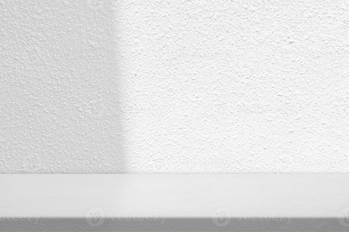Blank Table with White Stucco Wall Texture Background with Light Beam and Shadow photo