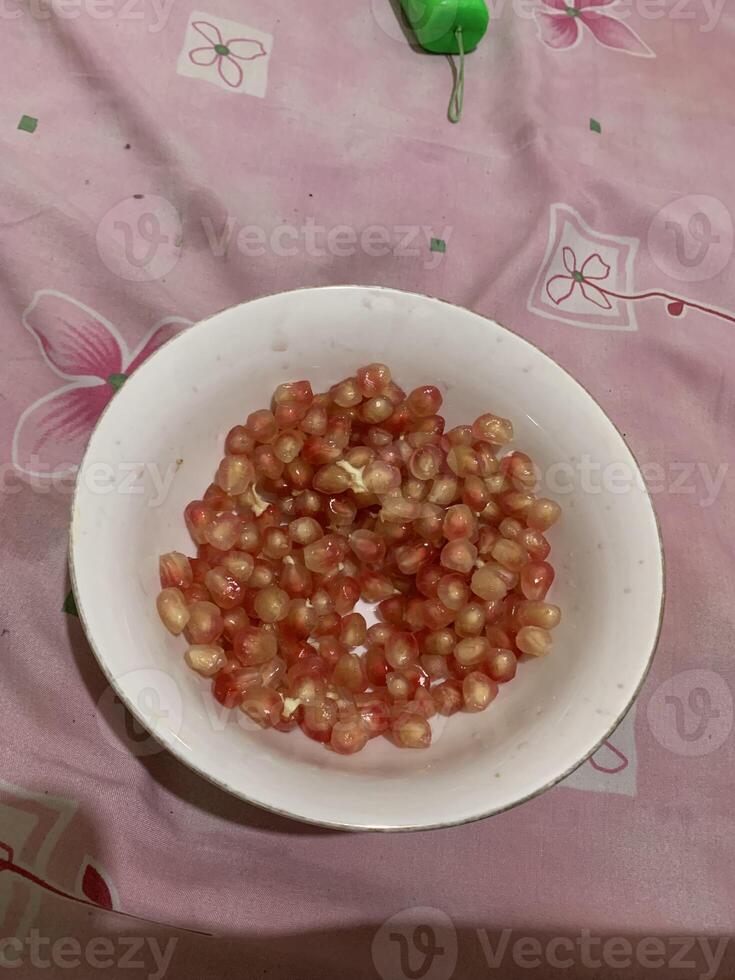 pomegranate seeds on white plate photo