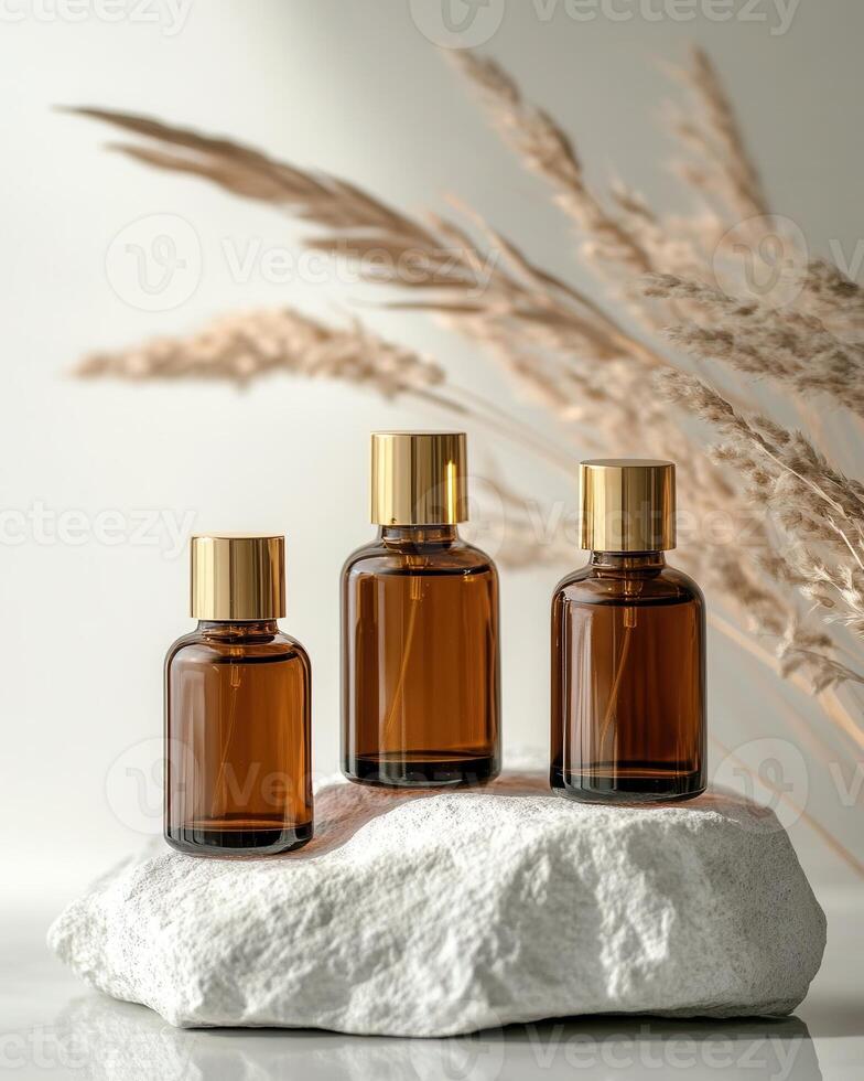 Three bottles of essential oils on a rock photo