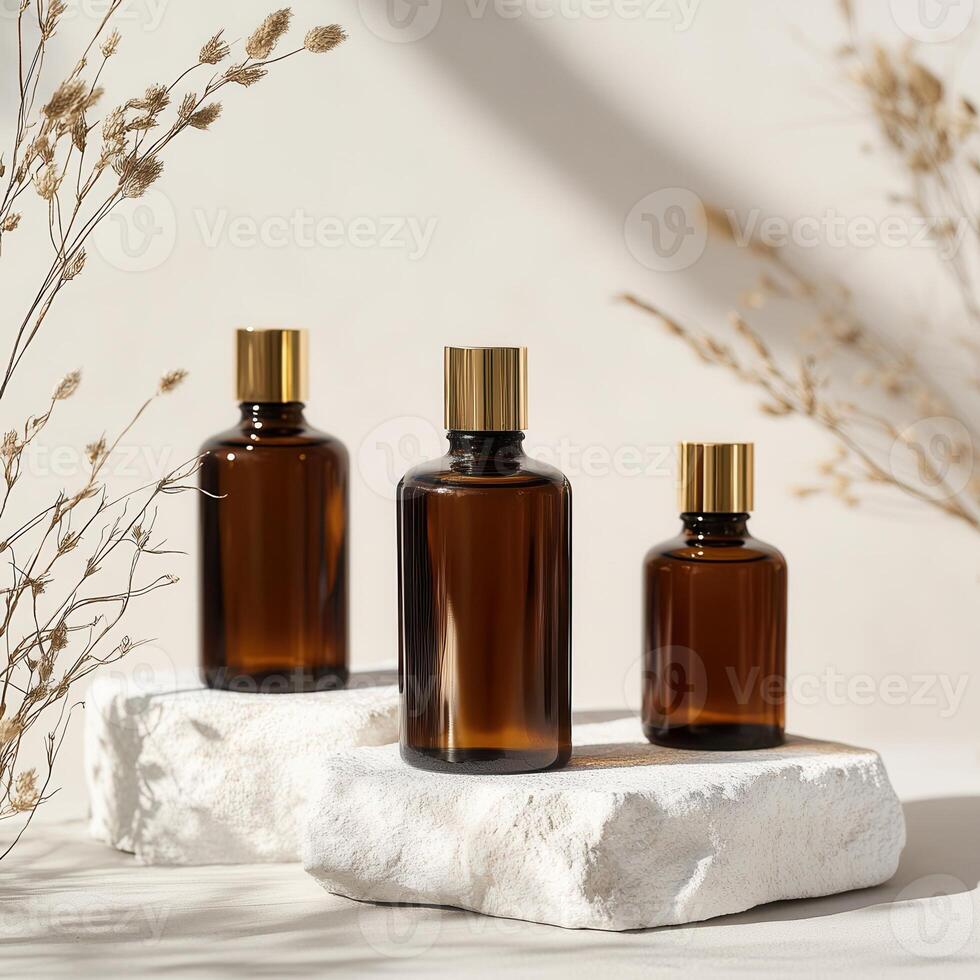 Three bottles of essential oils sit on a white surface photo