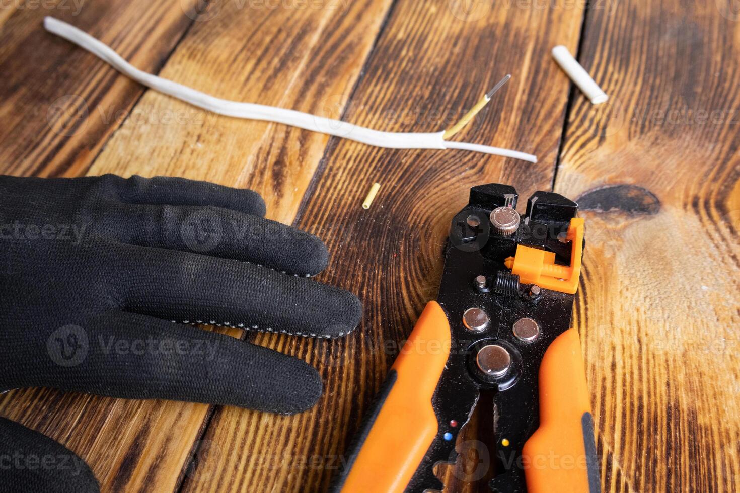Mechanical stripper for stripping electrical cable insulation. An electrician's tool. Expose the wires photo